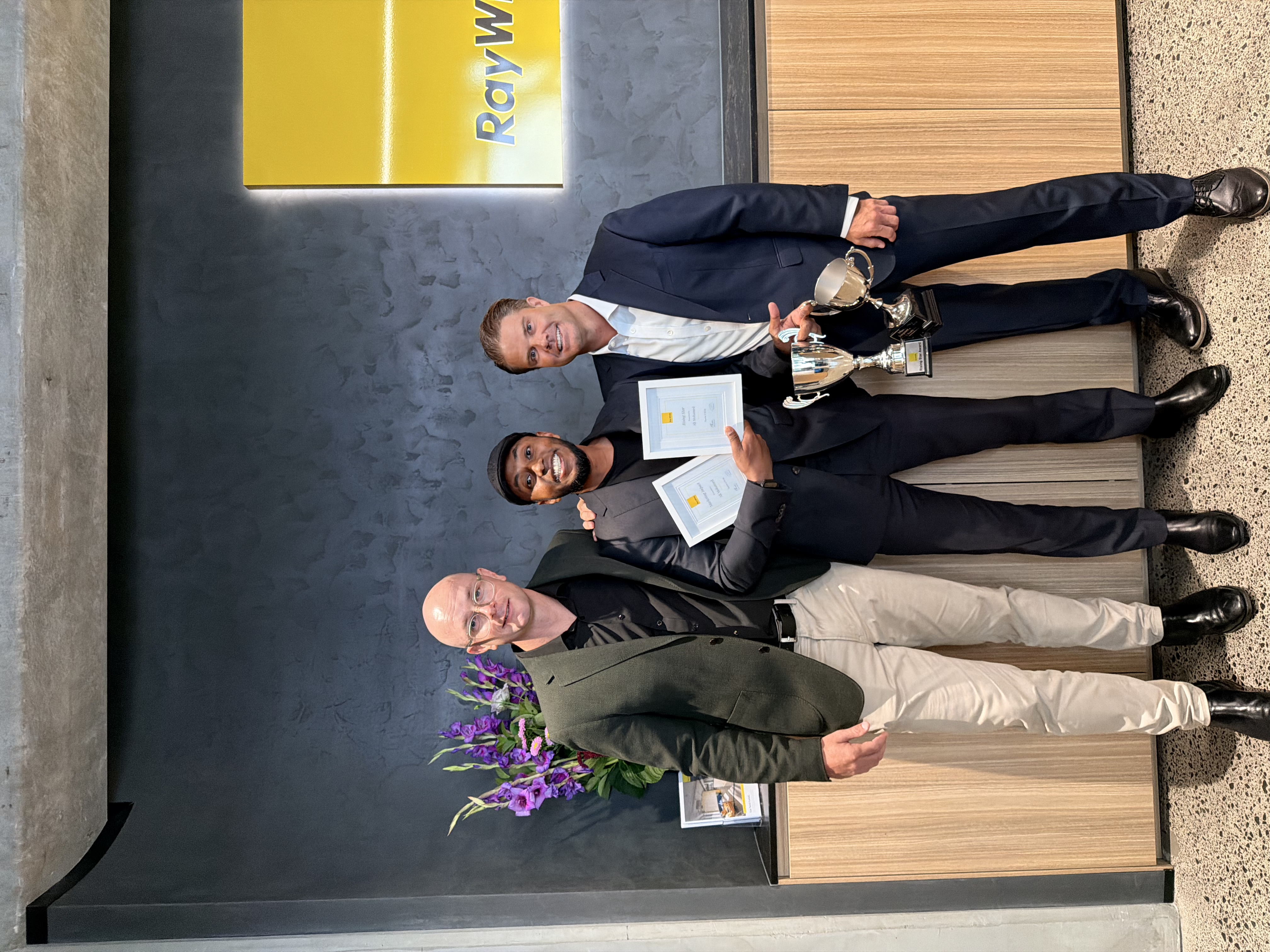 Ali Mohamed collecting awards at Ray White
